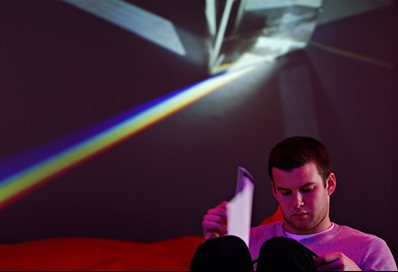 Student with notes with Pink Floyd poster behind him